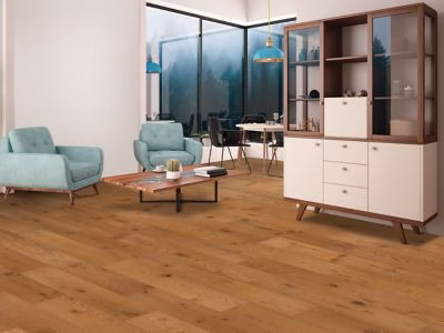 Quick-Step Centoria Aster Oak showing golden brown oak flooring in a furnished living room