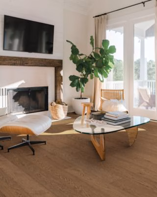 Quick-Step Perrano Margrove Oak showing brown oak flooring beside a fireplace