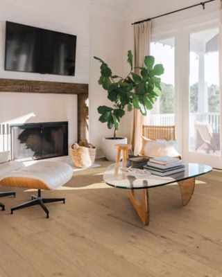 Quick-Step Perrano Peat Oak showing medium brown oak flooring beside a fireplace